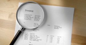 magnifying glass over an invoice
