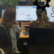 2 people looking at computer screen.