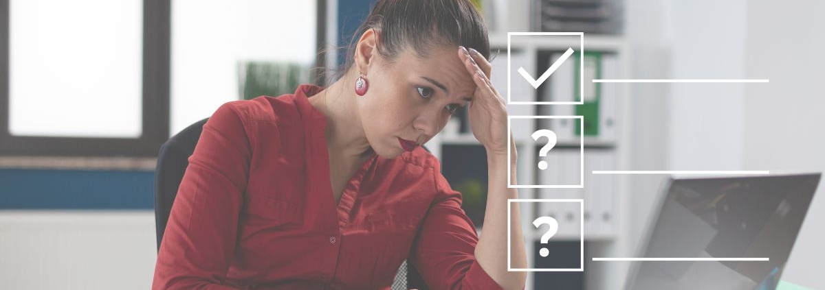 Women sitting at desk looking at her screen looking frustrated